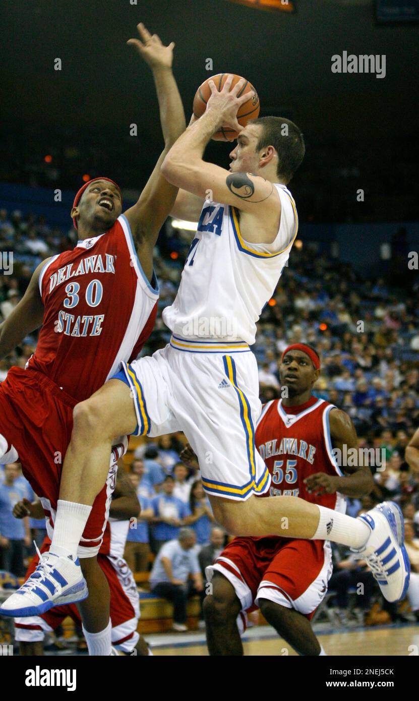 UCLA's Reeves Nelson, right, is fouled by Delaware State's Marcus Neal,  left, as he shoots during the first half of their NCAA college basketball  game in Los Angeles on Sunday, Dec. 27,