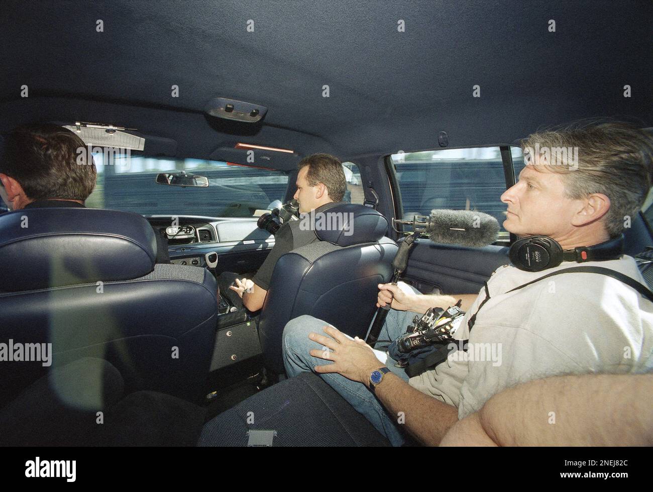 Soundman Richard Hummel sits in the back of a Los Angeles Police