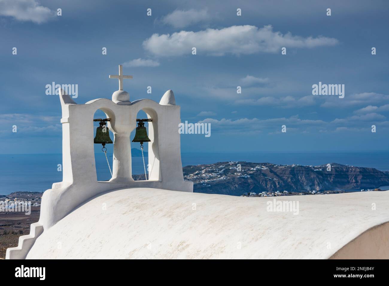 Characteristic whitewashed bell tower with curved roof, Santorini Stock Photo