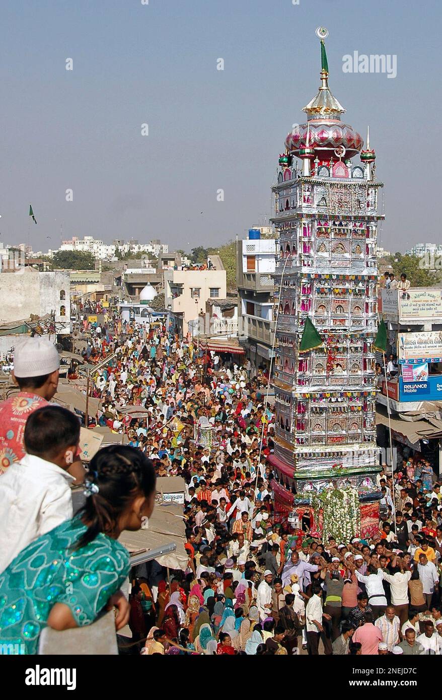 Children watch as Muslims carry replica of a tomb, during the Ashura  procession in Ahmadabad, India, Monday, Dec. 28, 2009. Ashura, which falls  on the 10th day of Muharram under the Islamic