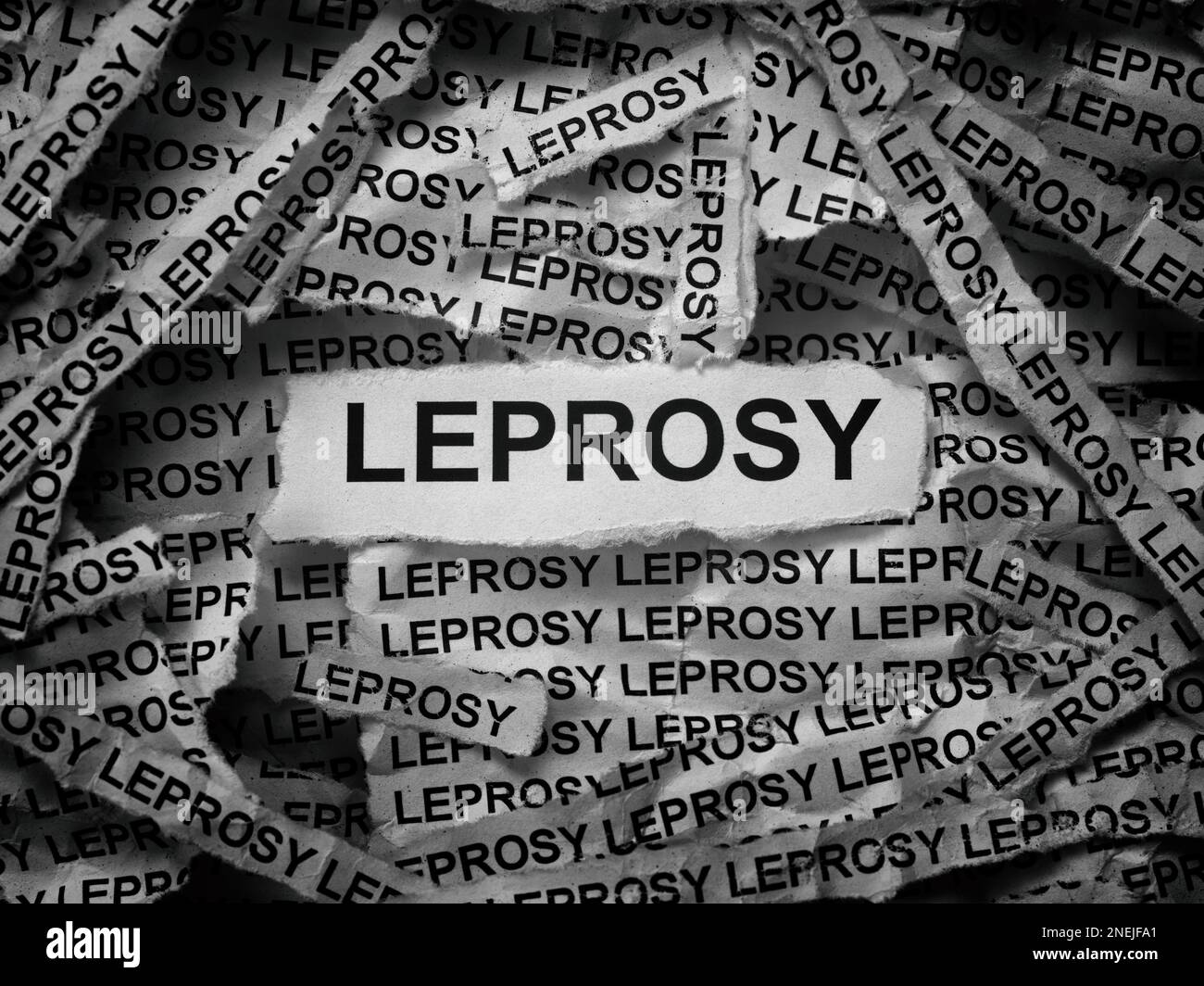 Strips of newspaper with the words Leprosy typed on them. Black and white. Close up. Stock Photo