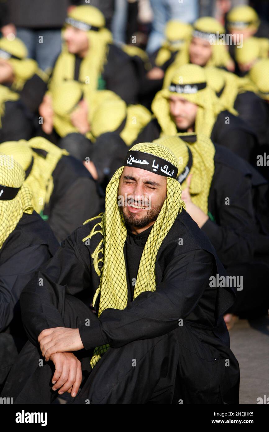 Lebanese Hezbollah supporters react during Ashoura day in Beirut's southern suburbs, Lebanon, Sunday, Dec. 27, 2009. Sunday's commemorations marked the climax of Ashoura, the yearly mourning period in which Shiite Muslims remember the seventh century death of the Prophet Muhammad's grandson, Imam Hussein, in a battle in the central city of Karbala. (AP Photo/Bilal Hussein) Stock Photo