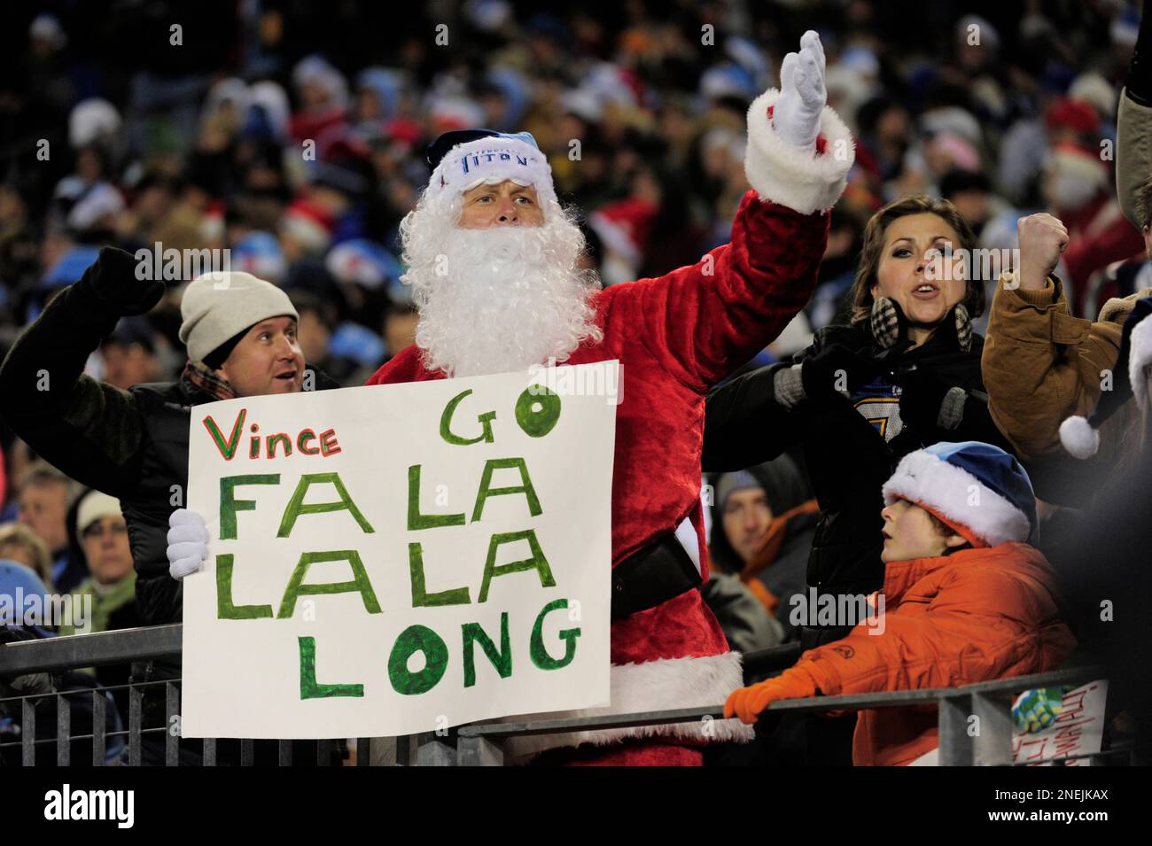 A Tennessee Titans fan is dressed as Santa as he watches the