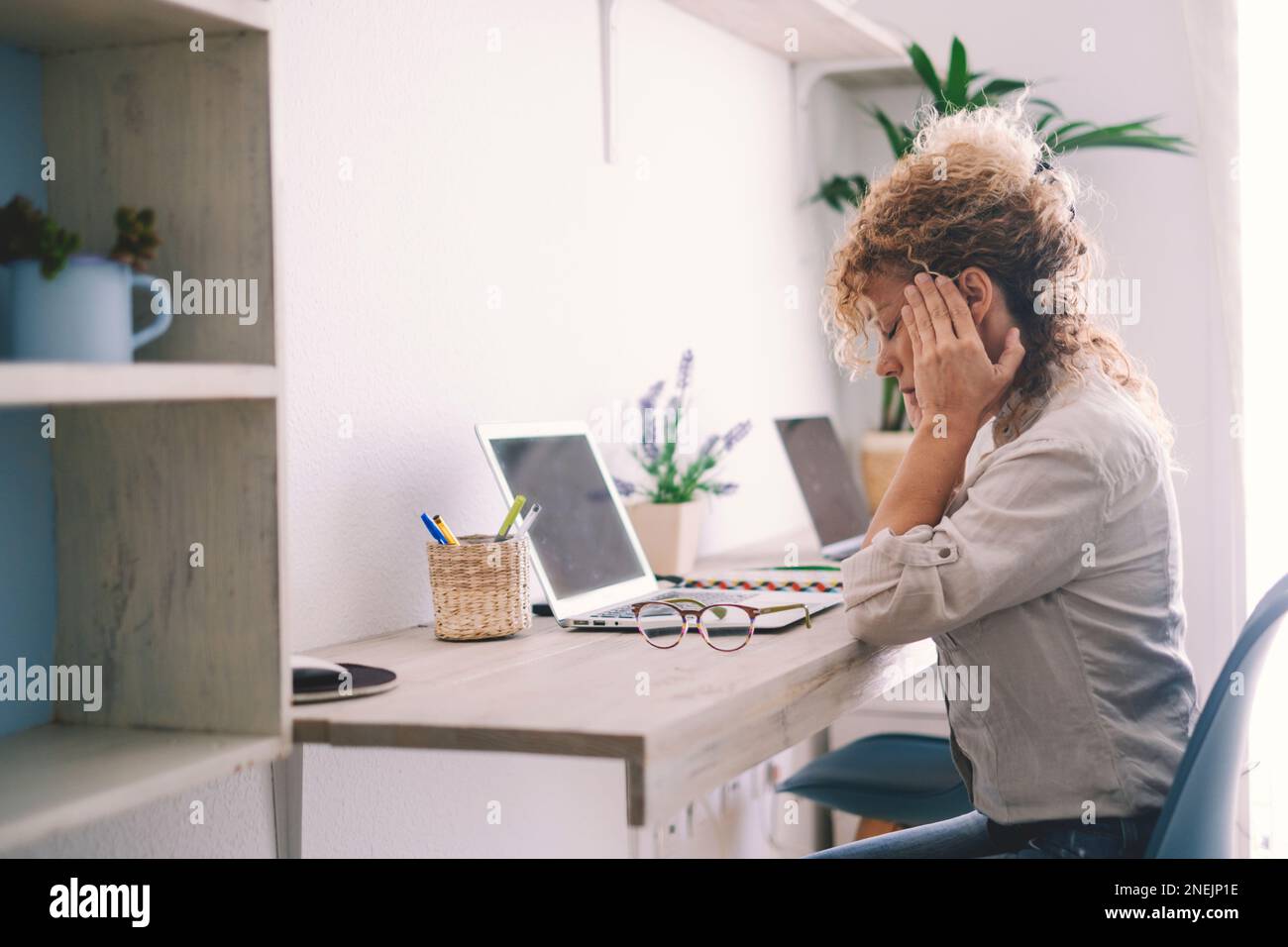 Tired young woman touch stiff neck feeling hurt joint back pain rubbing