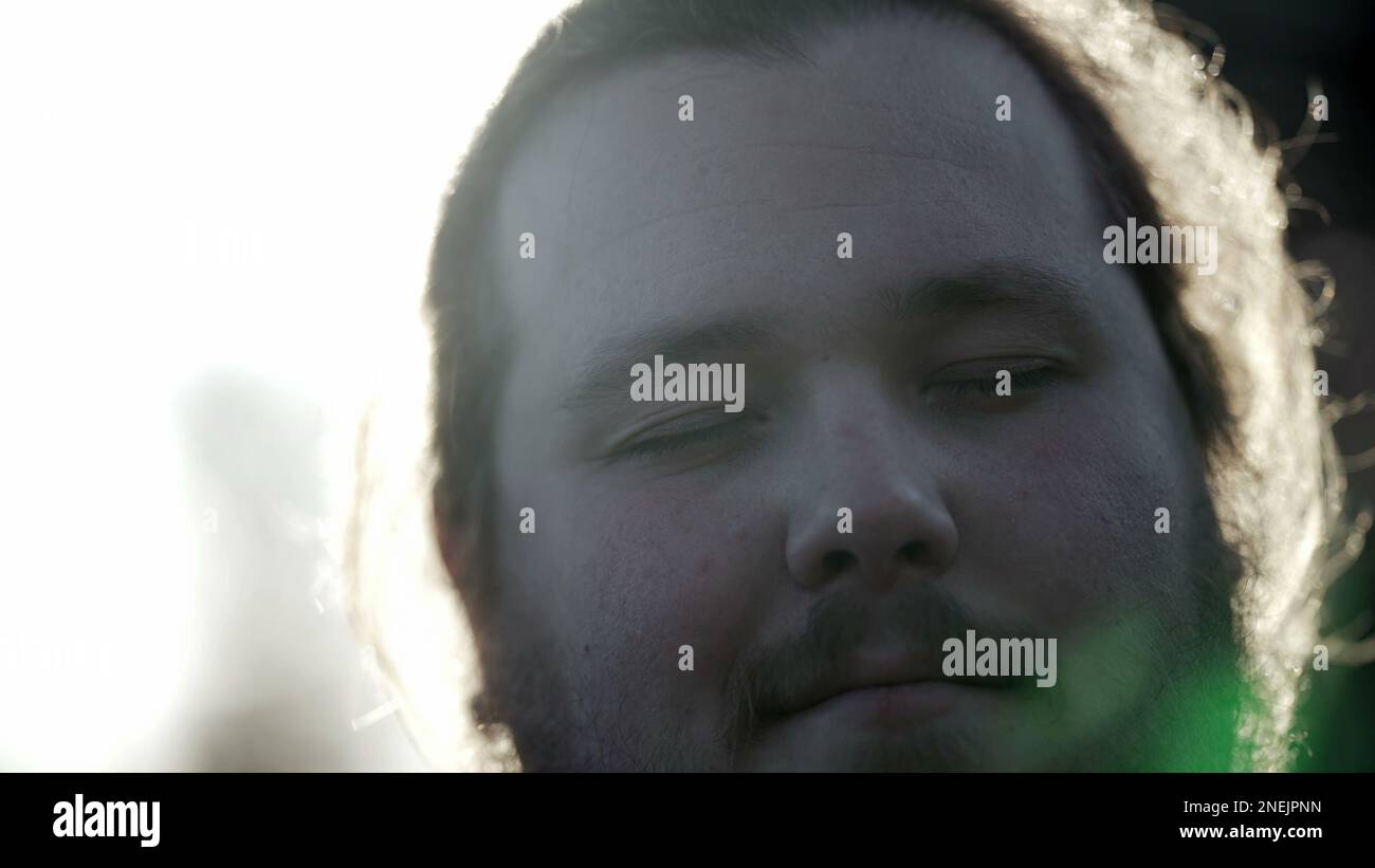 Young man with eyes closed in meditation. Portrait of an overweight ...