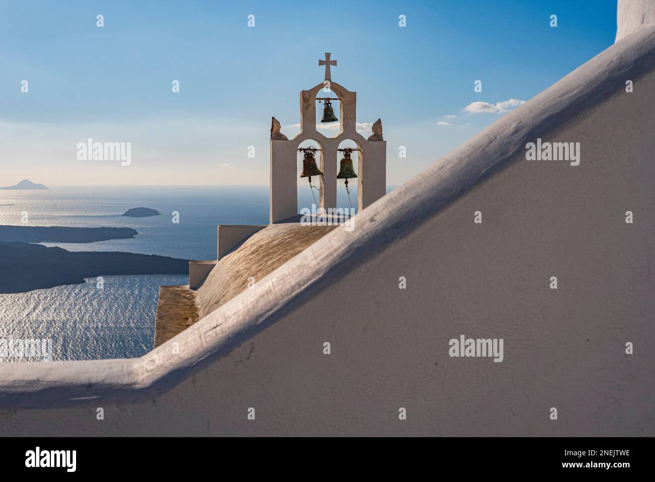 Characteristic whitewashed bell tower overlooking the caldera, Santorini Stock Photo