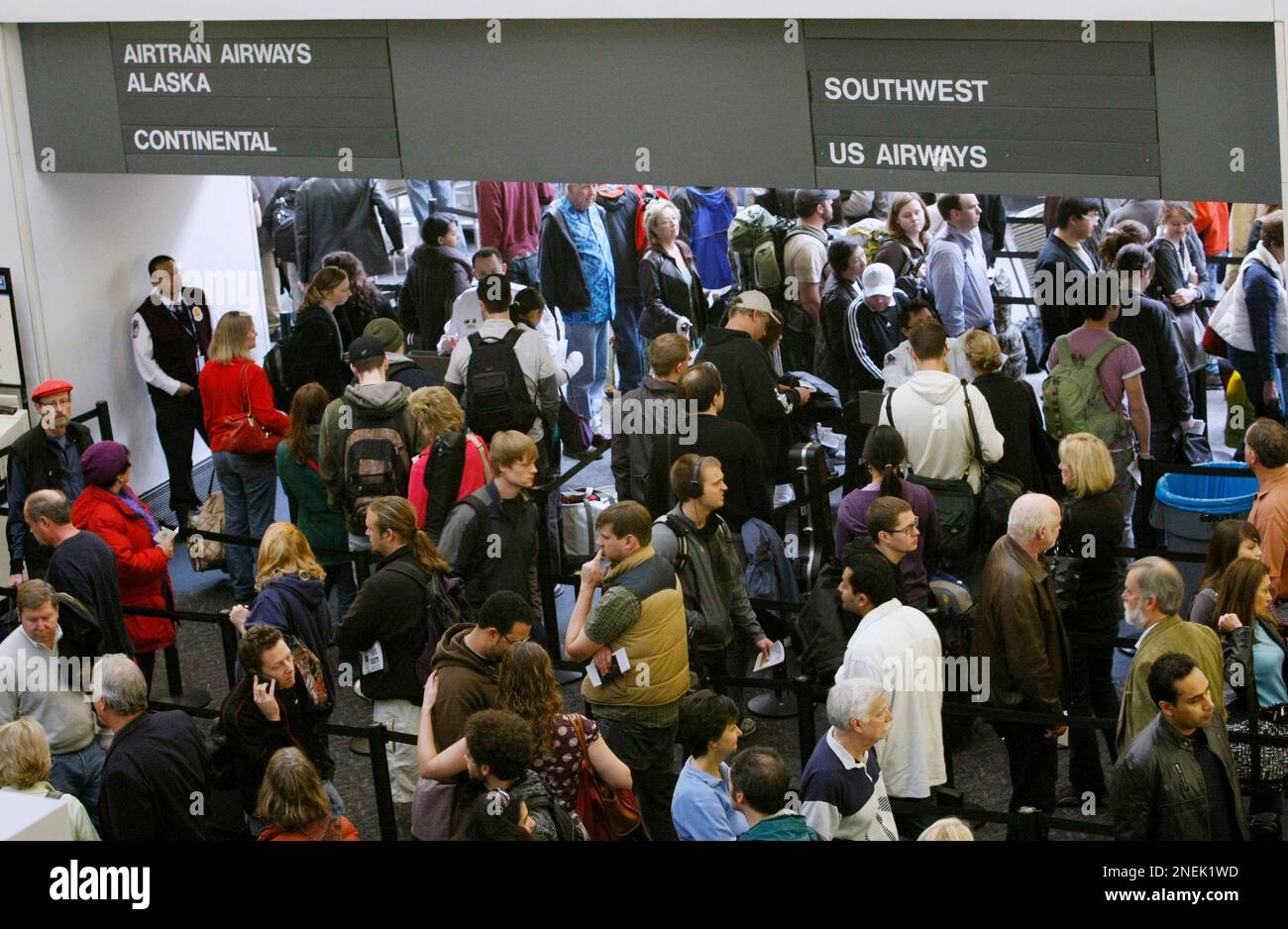 Travelers wait in to enter terminals at the San Francisco International  Airport in San Francisco, Monday, Dec. 21, 2009. Shoppers pack malls,  shippers fight icy roads to deliver packages and fliers negotiate