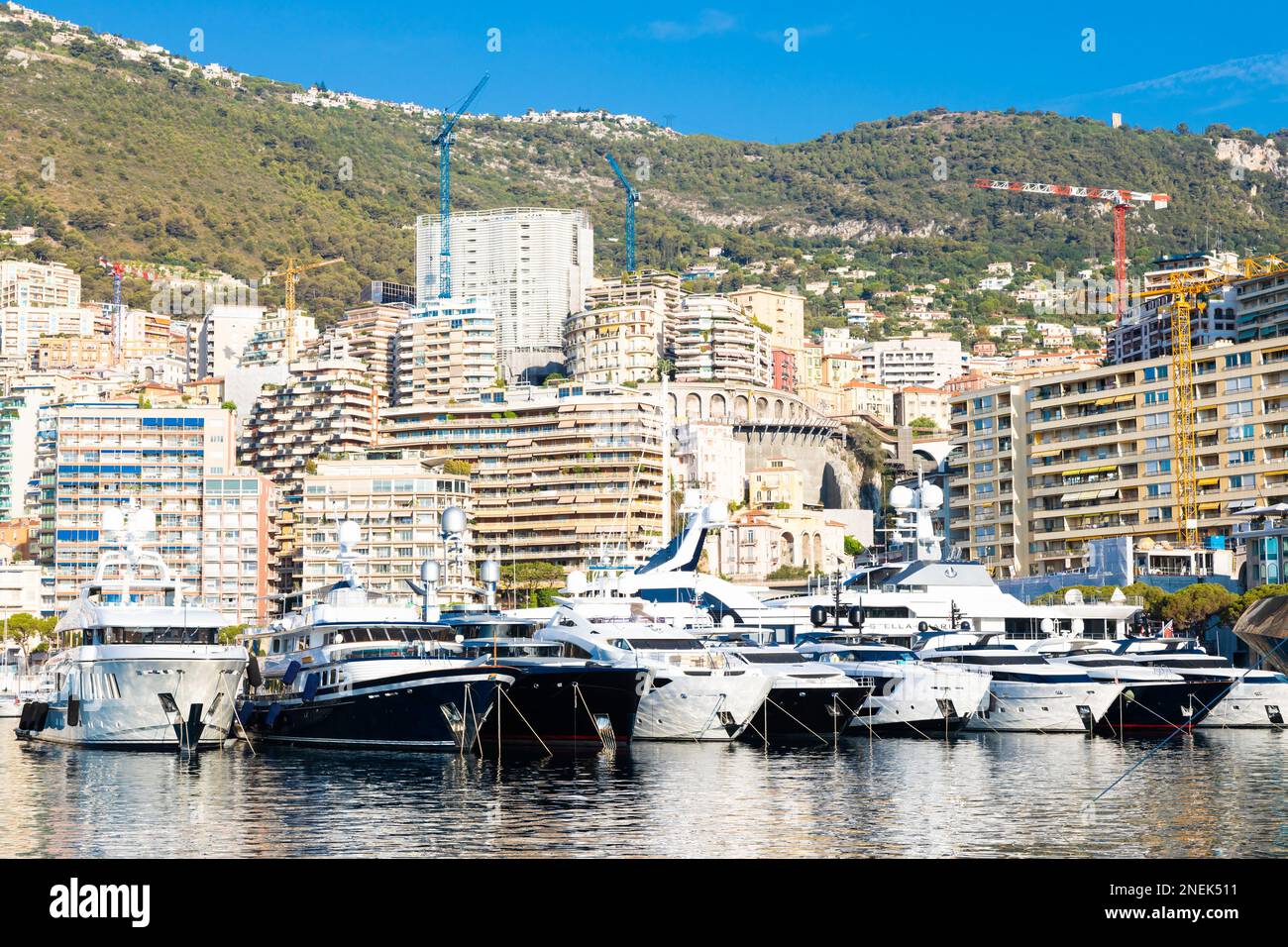 Monte Carlo, Monaco - August 2022: Port Hercule with luxury yachts,  boats, and scenery skyline Stock Photo