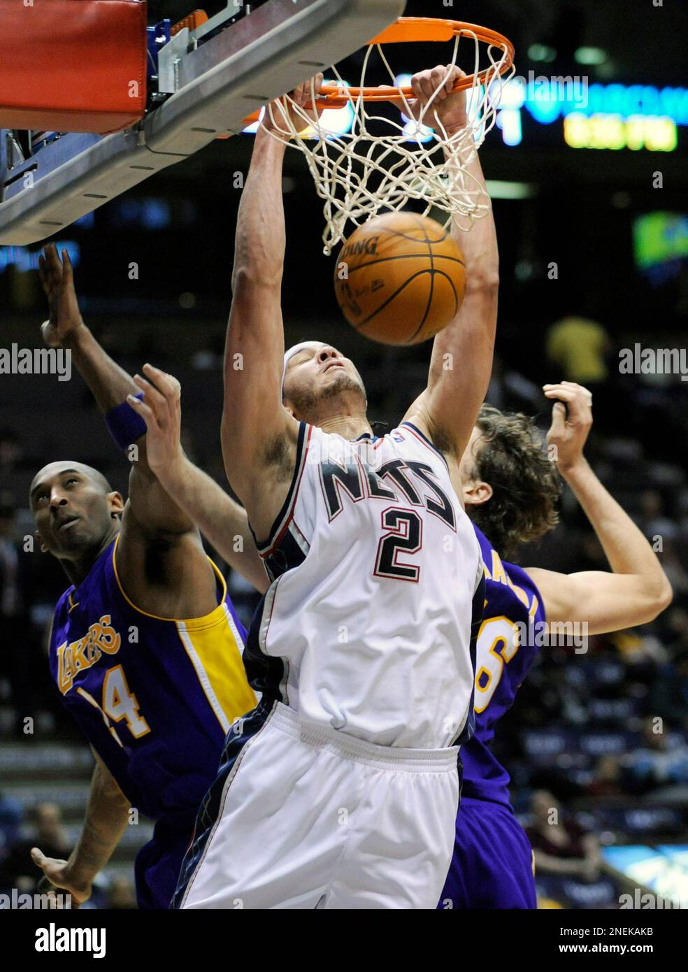 New Jersey Nets' Josh Boone (2) dunks the ball over Los Angeles Lakers' Kobe  Bryant, left, and Pau Gasol, of Spain, during the second quarter of an NBA  basketball game Saturday, Dec.