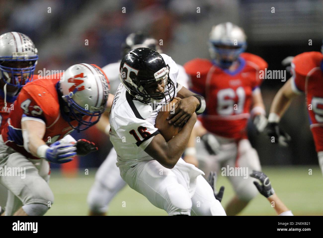 Euless Trinity's Willie Hubbard (16) is hit by Austin Westlake defender