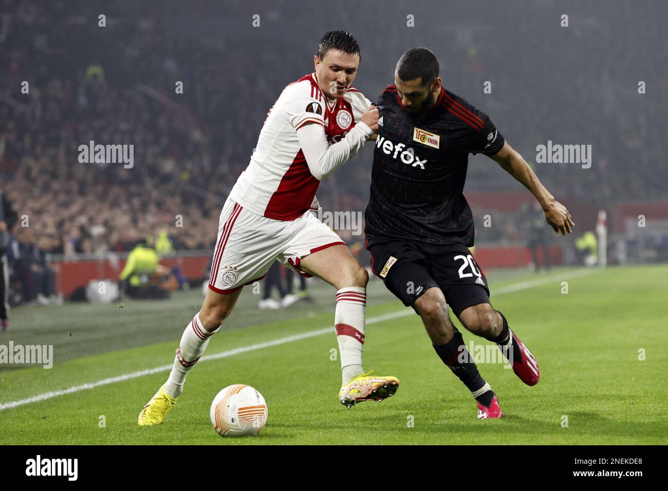 AMSTERDAM - (l-r) Steven Berghuis of Ajax, Aissa Laidouni of 1. FC Union Berlin during the UEFA Europa league play-off match between Ajax Amsterdam and FC Union Berlin at Johan Cruijff ArenA on February 16, 2023 in Amsterdam, Netherlands. ANP MAURICE VAN STONE Stock Photo