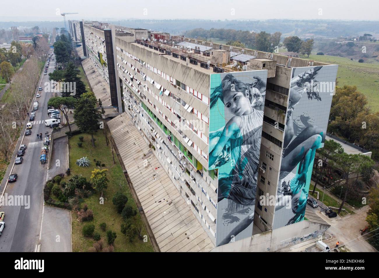 Rome, Italy. 16th Feb, 2023. (EDITORS NOTE: Image taken with drone).A 40-metre-long mural created by the Dutch street artist JDL (alter ego of the artist Judith de Leeuw) on a wall of the Corviale, a 958-metre-long public housing building (also called '' the great serpent'' due to its shape) in Rome. The subject draws inspiration from the myth of Icarus, a metaphor for a society intent on following a path that pays little attention to the precarious fate of the climate and the environment, leading it to self-destruction. (Credit Image: © Stefano Costantino/SOPA Images via ZUMA Press Wire) E Stock Photo