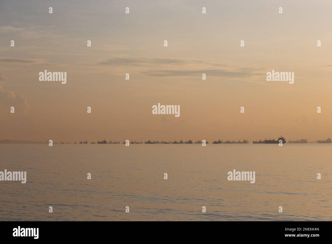 Container Ships off the Shore of Singapore, in the Singapore Strait, During Sunrise - Singapore Stock Photo