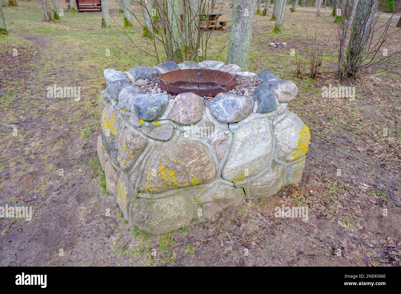 idyllic outdoor barbecue area - built with flat stones campfire place. For public use. Stock Photo