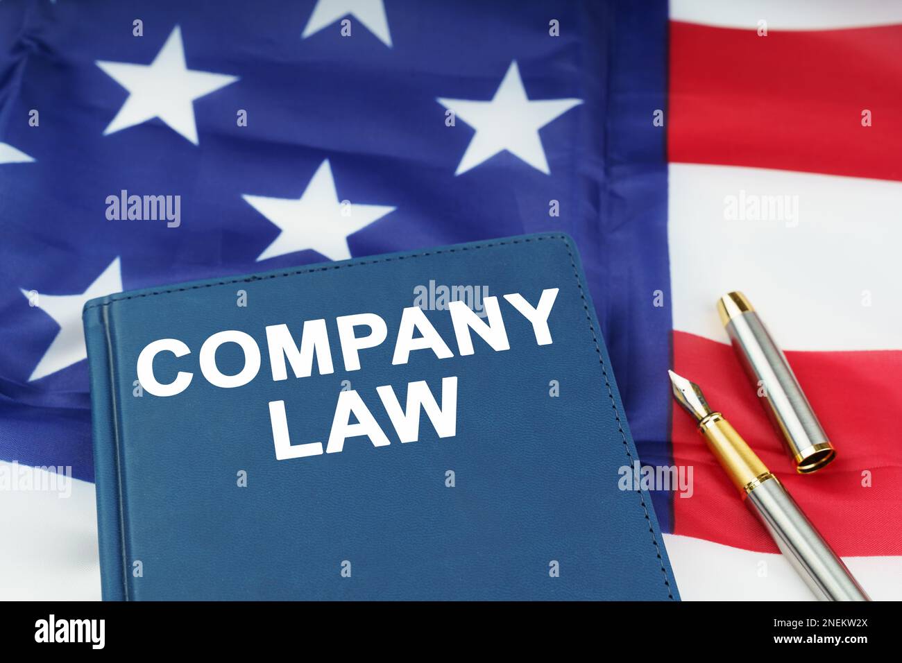 Law concept. On the US flag lies a pen and a book with the inscription
