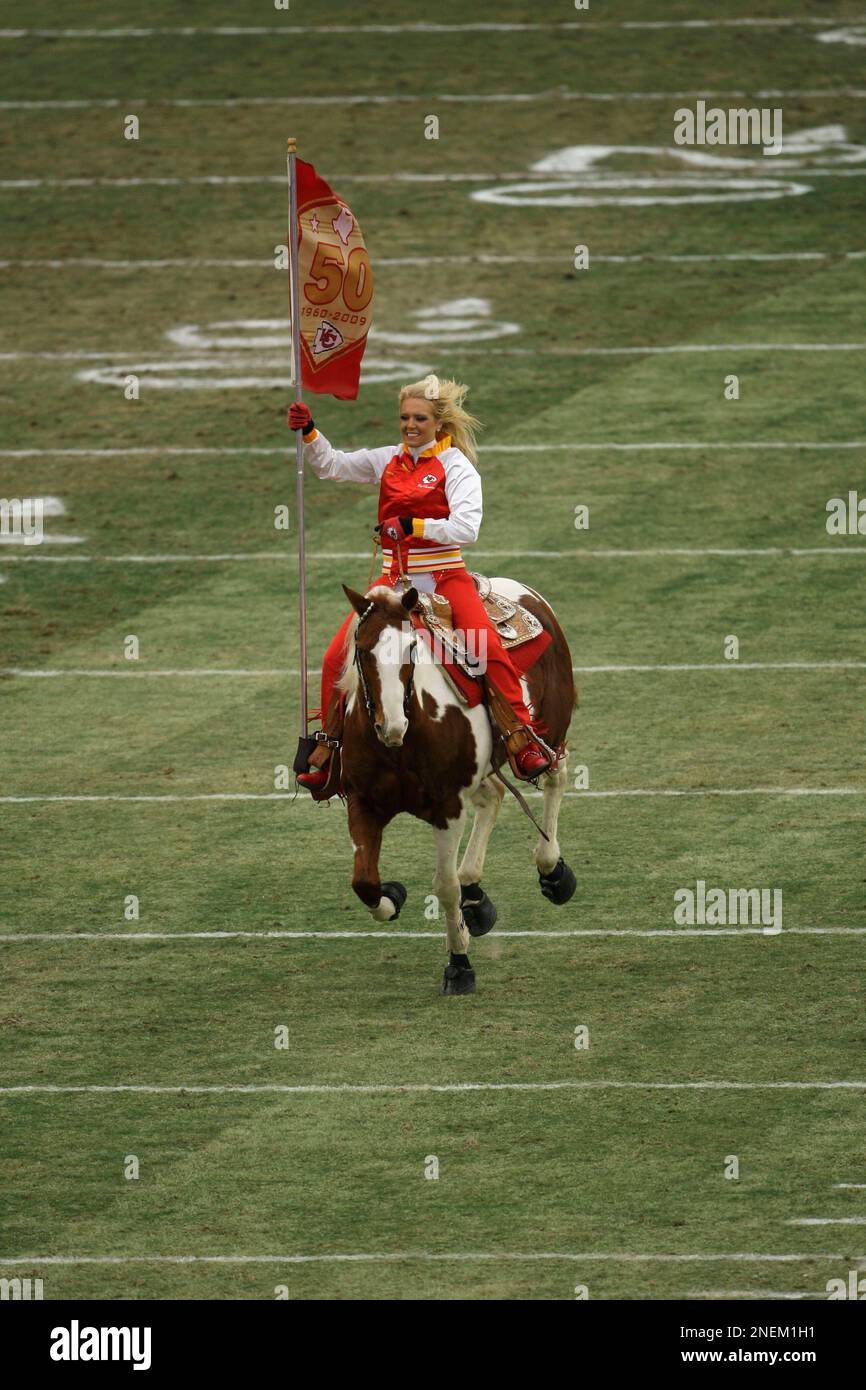 A Kansas City Chiefs cheerleader rides Chiefs mascot Warpaint during ...