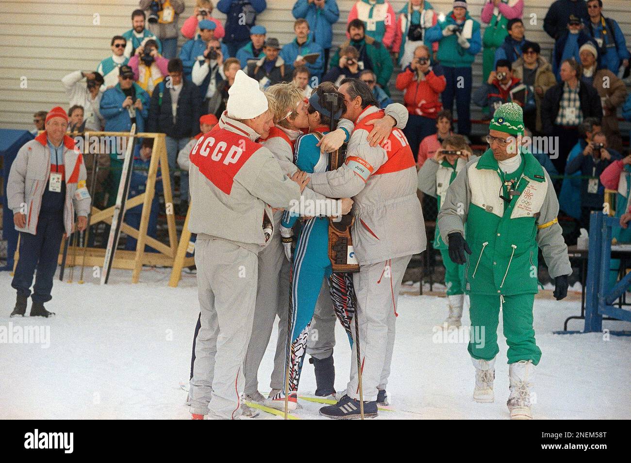 A jubilant Soviet team embraces and kisses Valeri Medvedtsev who won