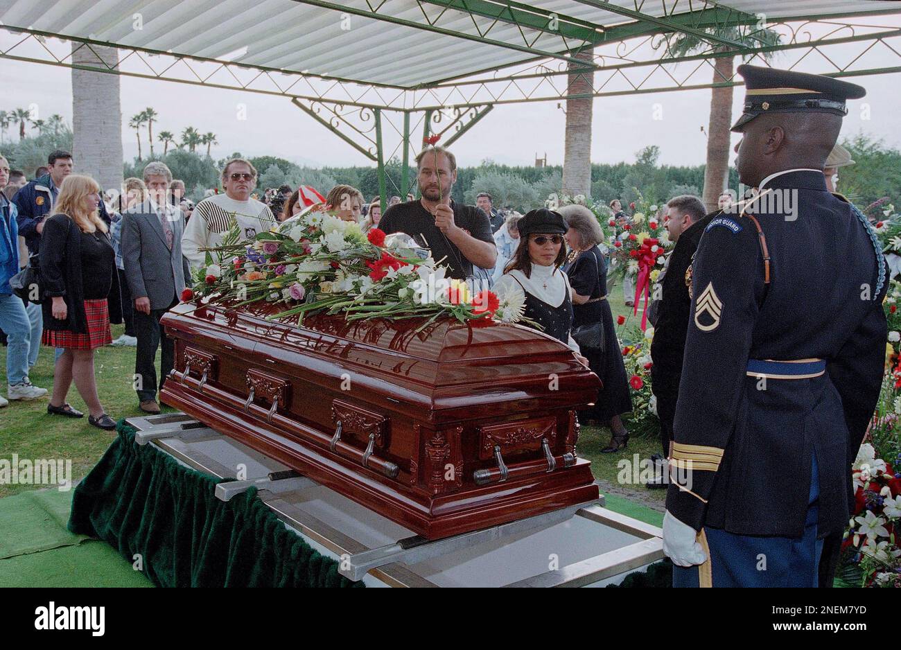 A mourner places arose on the casket of Congressman Sonny Bono, Friday