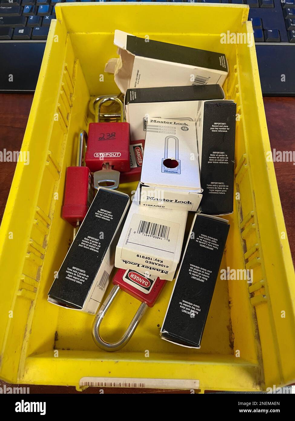 Lock out tag out locks locks in a yellow tote. High quality photo Stock