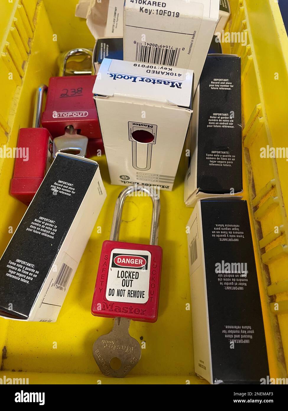 Lock out tag out locks locks in a yellow tote. High quality photo Stock