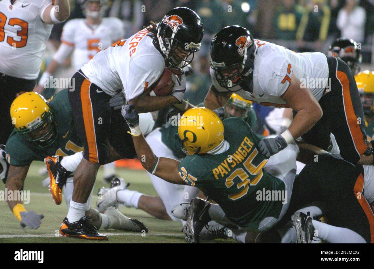 Oregon State's Jacquizz Rodgers (1) scores against Oregon's Spencer  Paysinger (35) during the first half of an NCAA college football game in  Eugene, Ore., Thursday Dec. 3, 2009. Oregon beat Oregon State