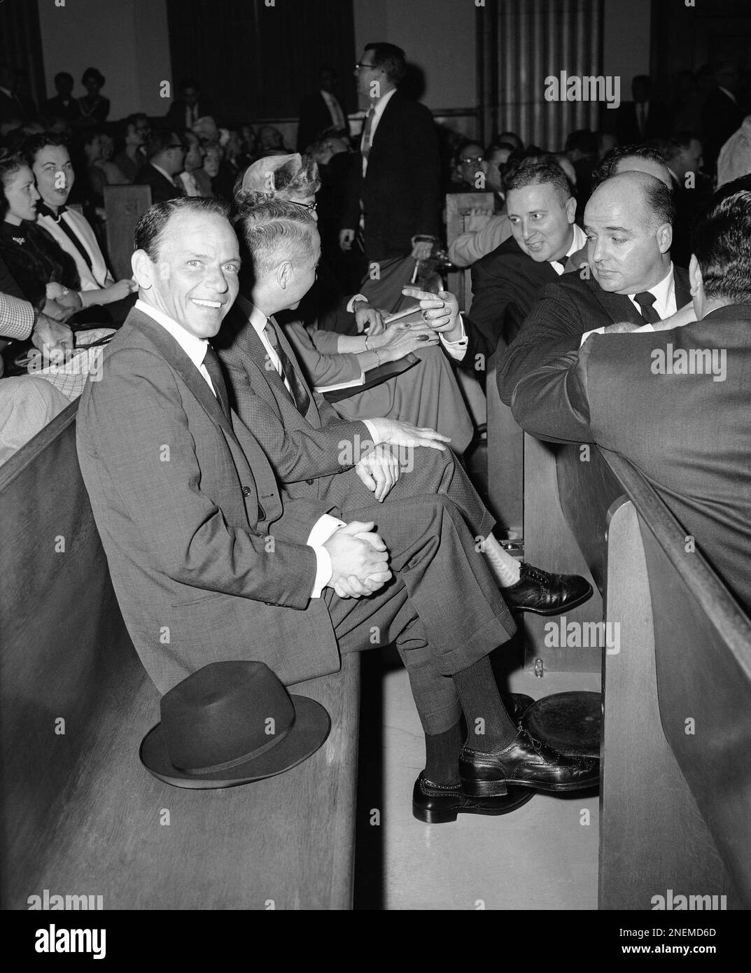 A smiling Frank Sinatra sits among the spectators waiting to testify before  a state legislative committee investigating the Hollywood sources for  so-called scandal magazine stores on Feb. 27, 1957 in Los Angeles., image size:1073x1390