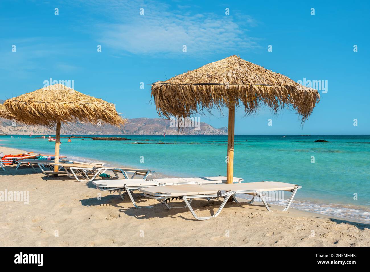View to sun loungers and straw parasols on the Elafonissi beach. Crete, Greece Stock Photo