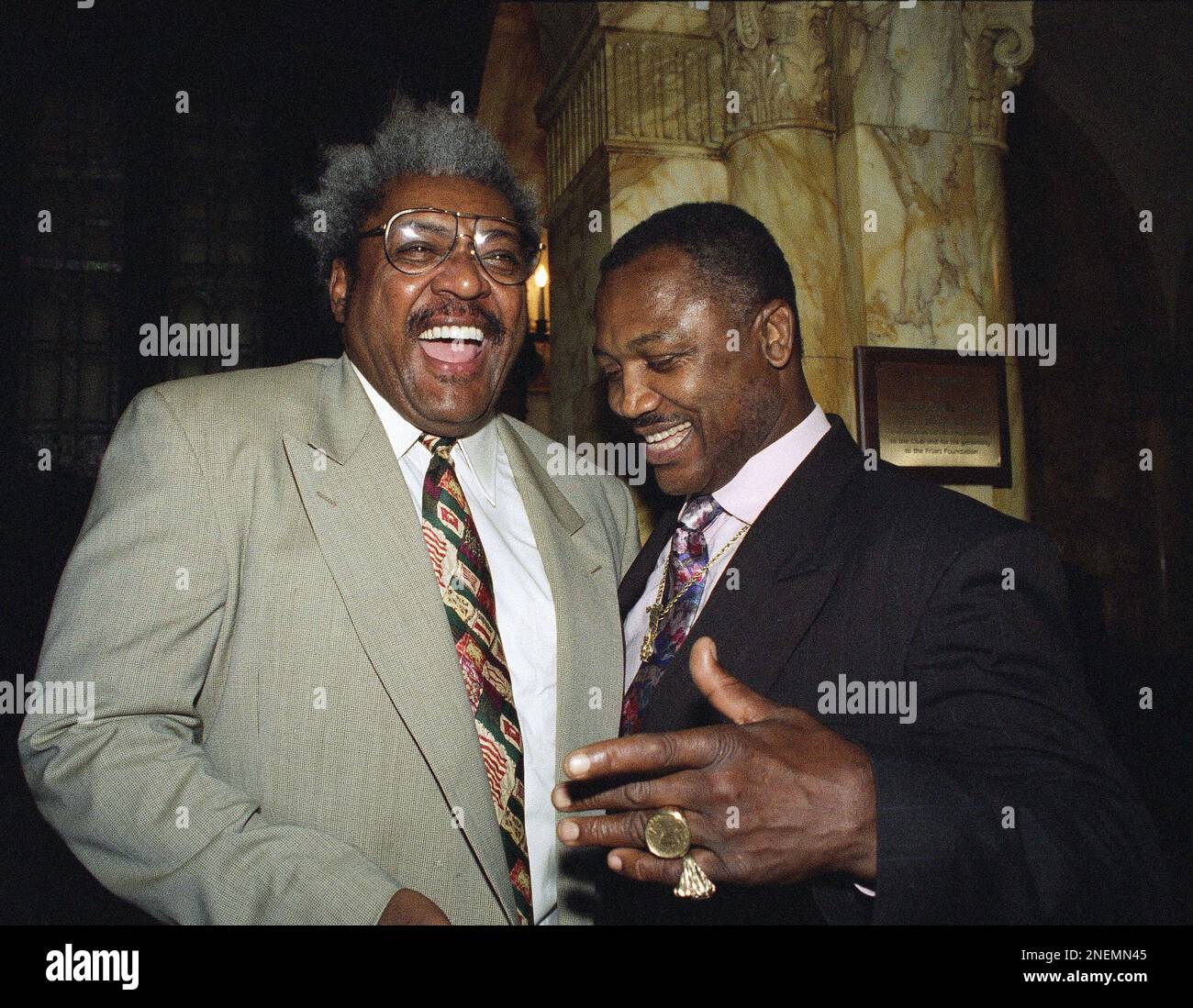 Boxing promoter Don King, left, and former heavy-weight champion Joe  Frazier, right, share a light moment during a memorial tribute for  sportscaster Howard Cosell hosted at the New York Friars Club on, image size:1300x1099