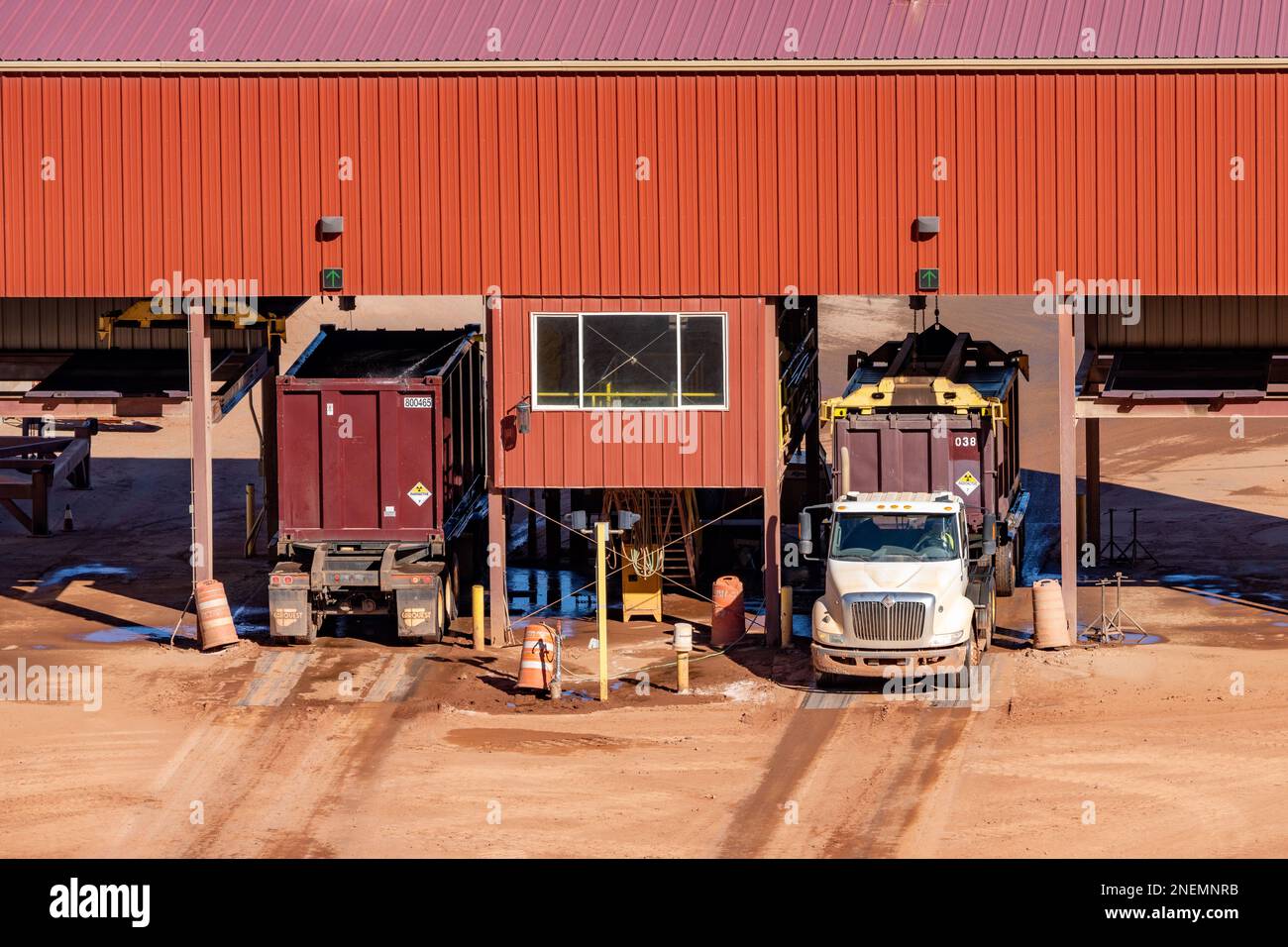 Container trucks have their containers capped or uncapped at his
