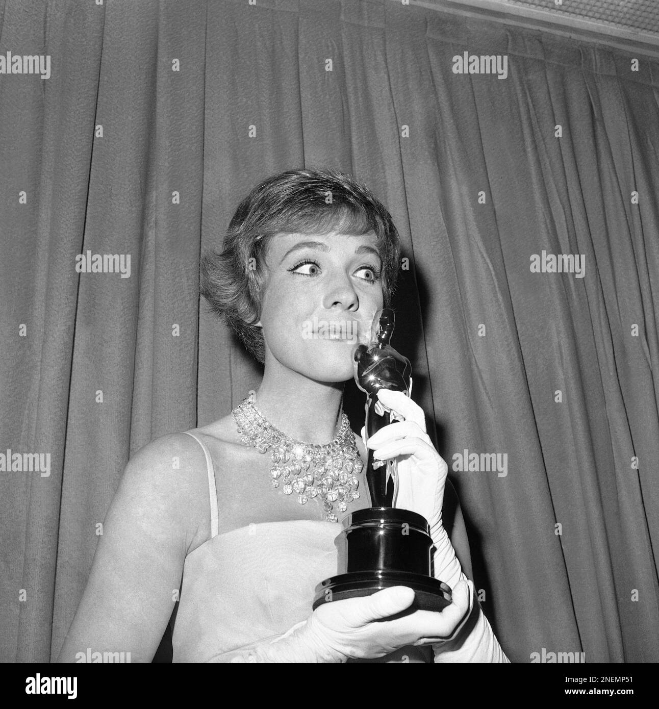 Julie Andrews holds her Oscar, April 6, 1965 in Santa Monica. (AP