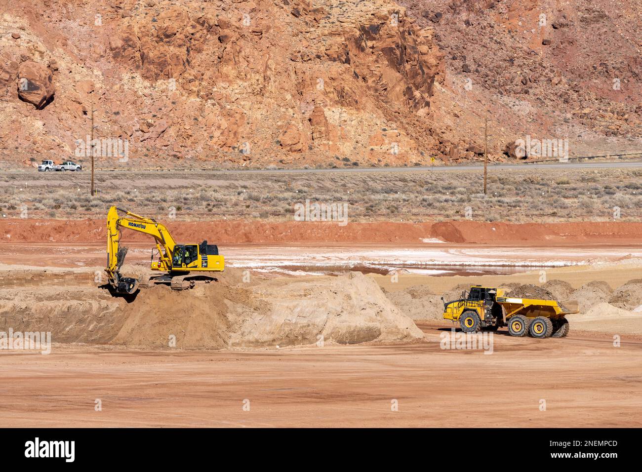 A heavy duty excavator works at the hazardous uranium tailings at the