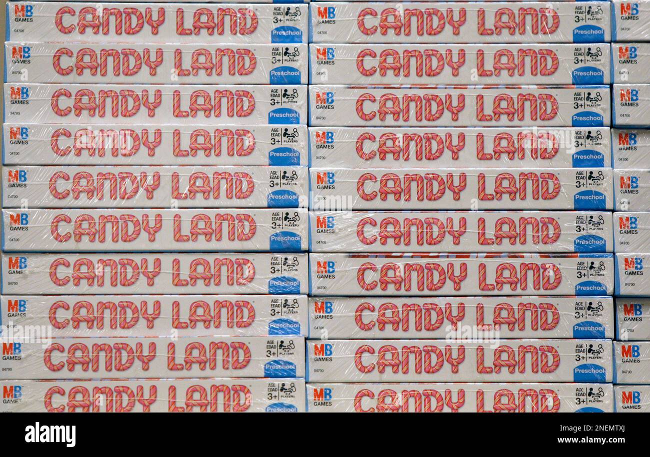 Stacks of the Milton Bradley game Candy Land sit on a shelf at the