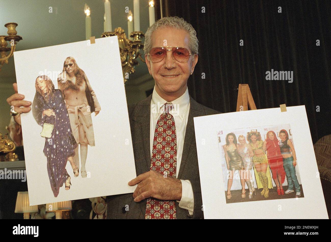 Fashion critic Mr. Blackwell holds pictures of the pop music group ?The