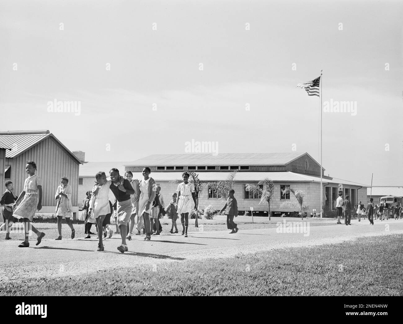 Children leaving from School are served Hot Lunches in Community Building, Okeechobee Migratory Labor Camp, Belle Glade, Florida USA, Marion Post Wolcott, U.S. Farm Security Administration, February 1941 Stock Photo