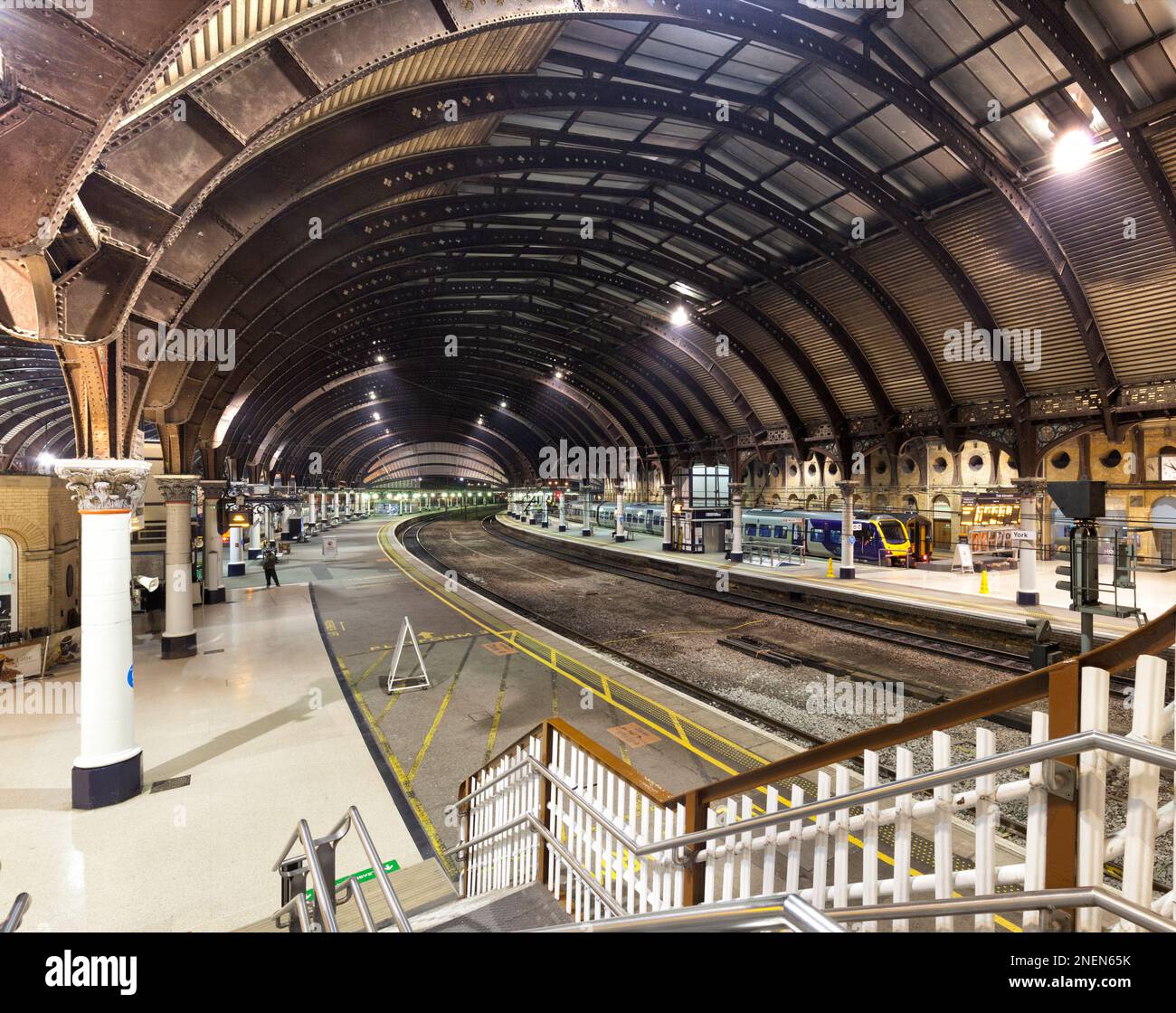 York railway station at night showing the overall roof and a Northern rail class 195 stabled Stock Photo