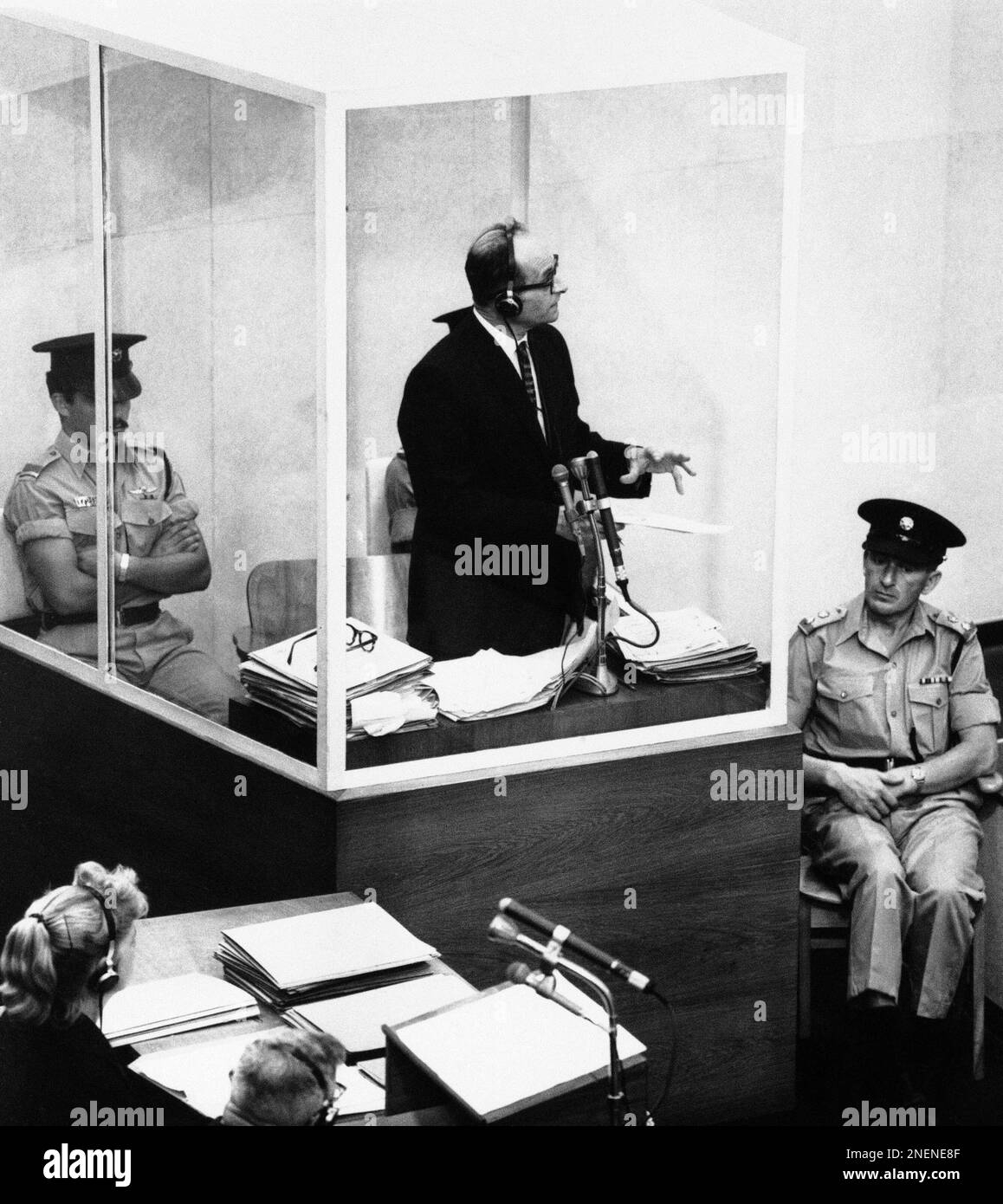 Adolf Eichmann turns toward judges bench as he emphasizes a point while testifying about Nazi documents during his trial in Jerusalem, July 3, 1961. The former Gestapo officer, on trial for criminal responsibility in the massacre of Jews during World War II, was on the witness stand for the 10th day, testifying in his own defense. (AP Photo) Stock Photo