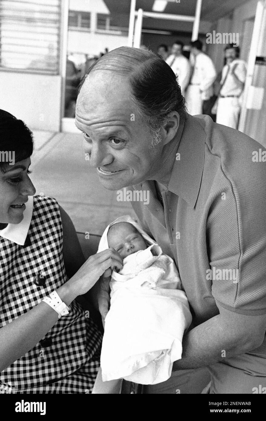 Comedian Don Rickles and his wife Barbara Rickles carry their son