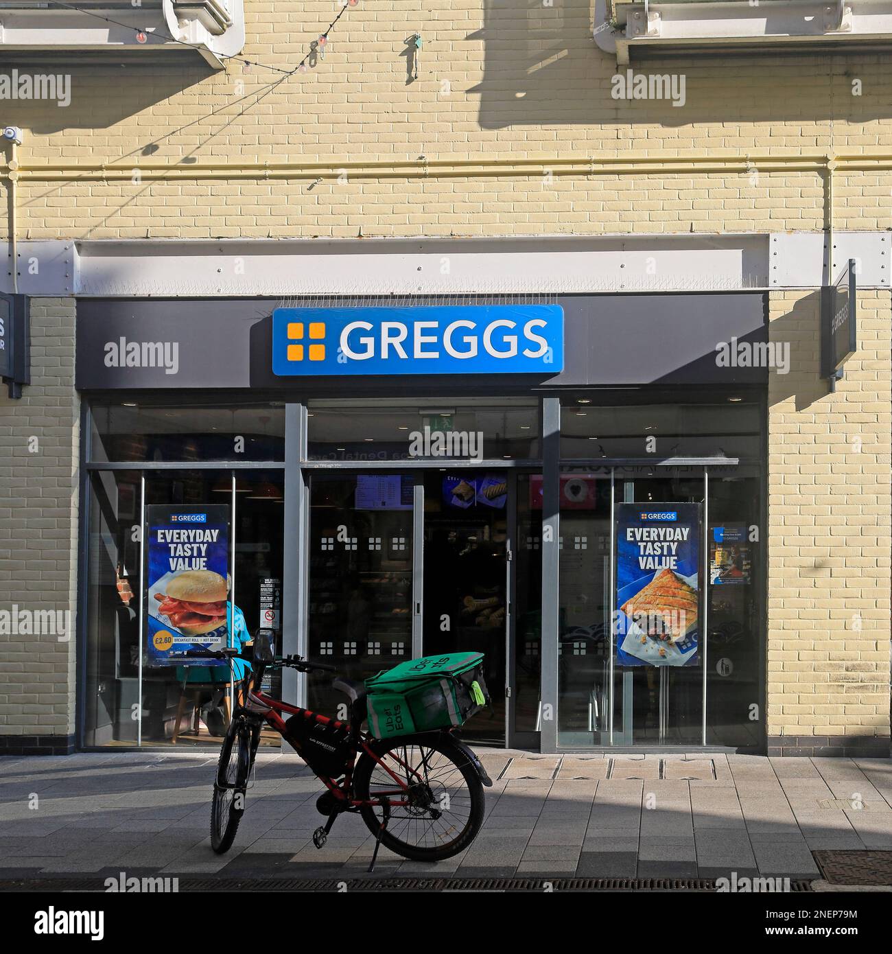 Greggs, Cardiff Bay store front with food delivery bicycle outside ...