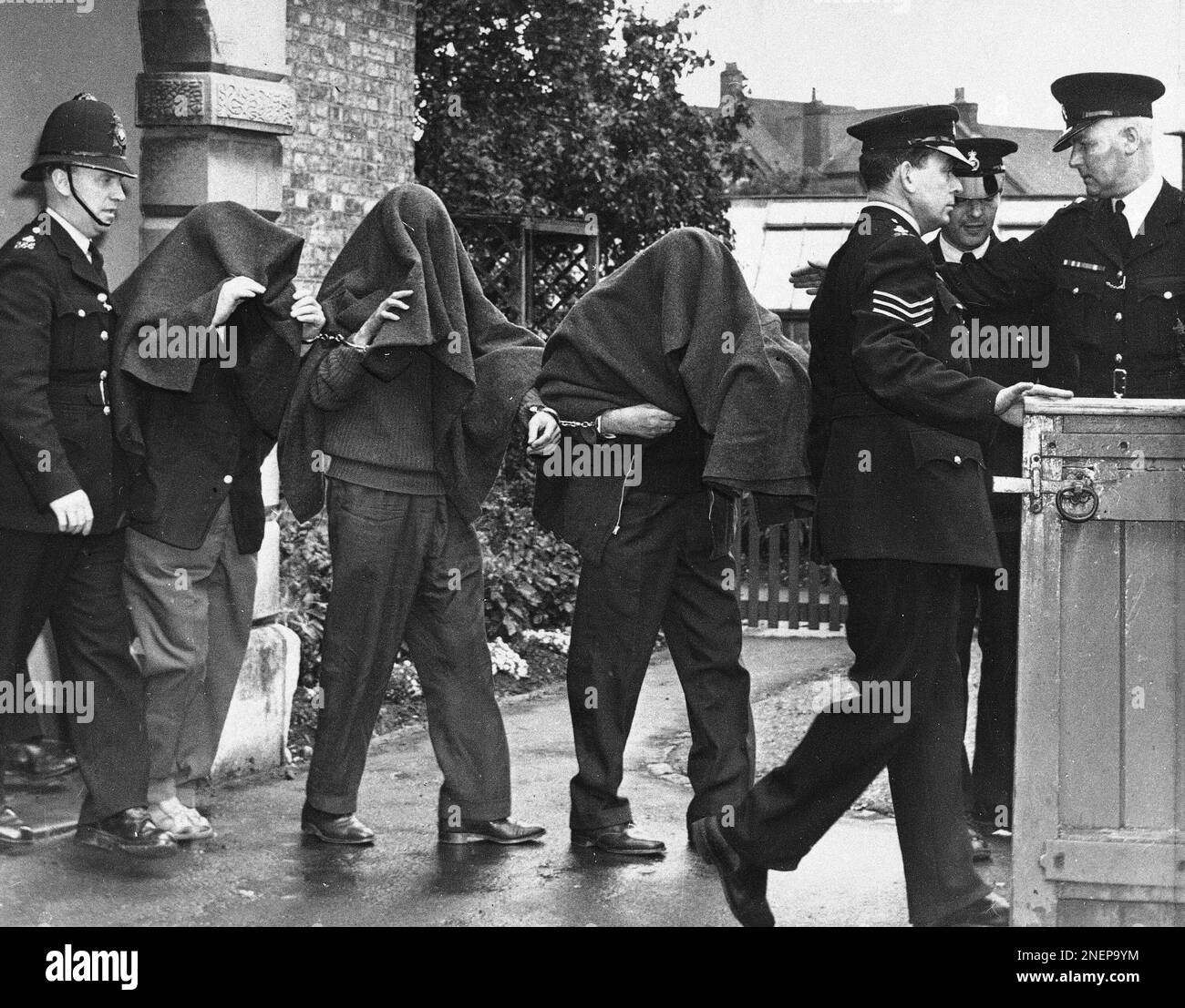 Three hooded and handcuffed men being led from court in Linslade ...