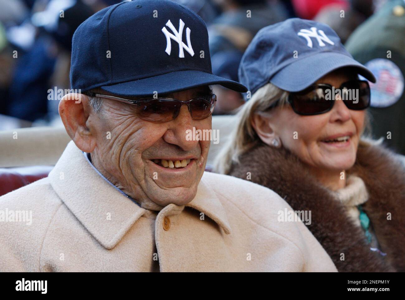 New York Yankees Hall of Fame catcher Yogi Berra, left, rides in a car