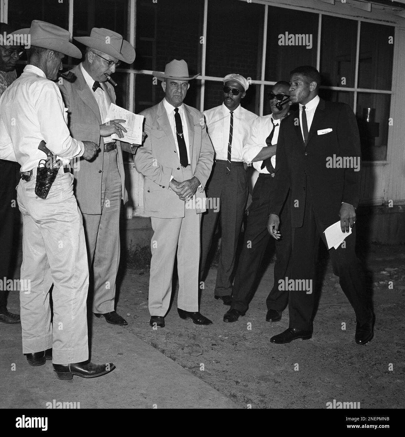 Harrison County Sheriff Earl Franklin, second from left, looks through