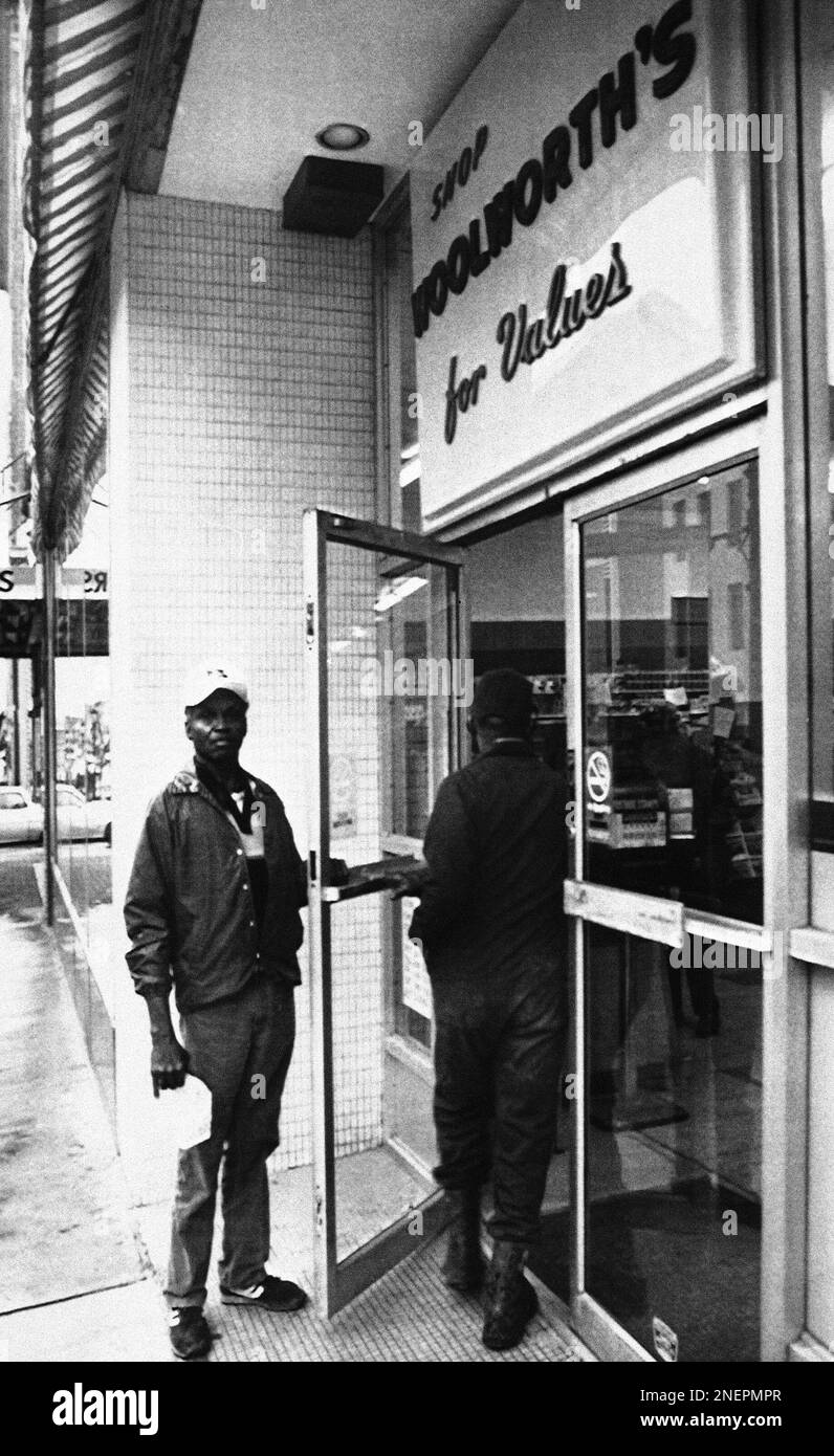 James Baker, left, prepares to enter the downtown Woolworth store in ...