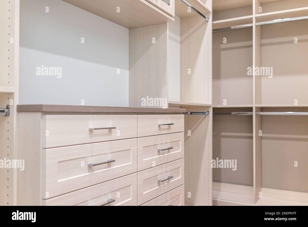 Spacious walkin closet shelves, chest of drawers in modern minimalist
