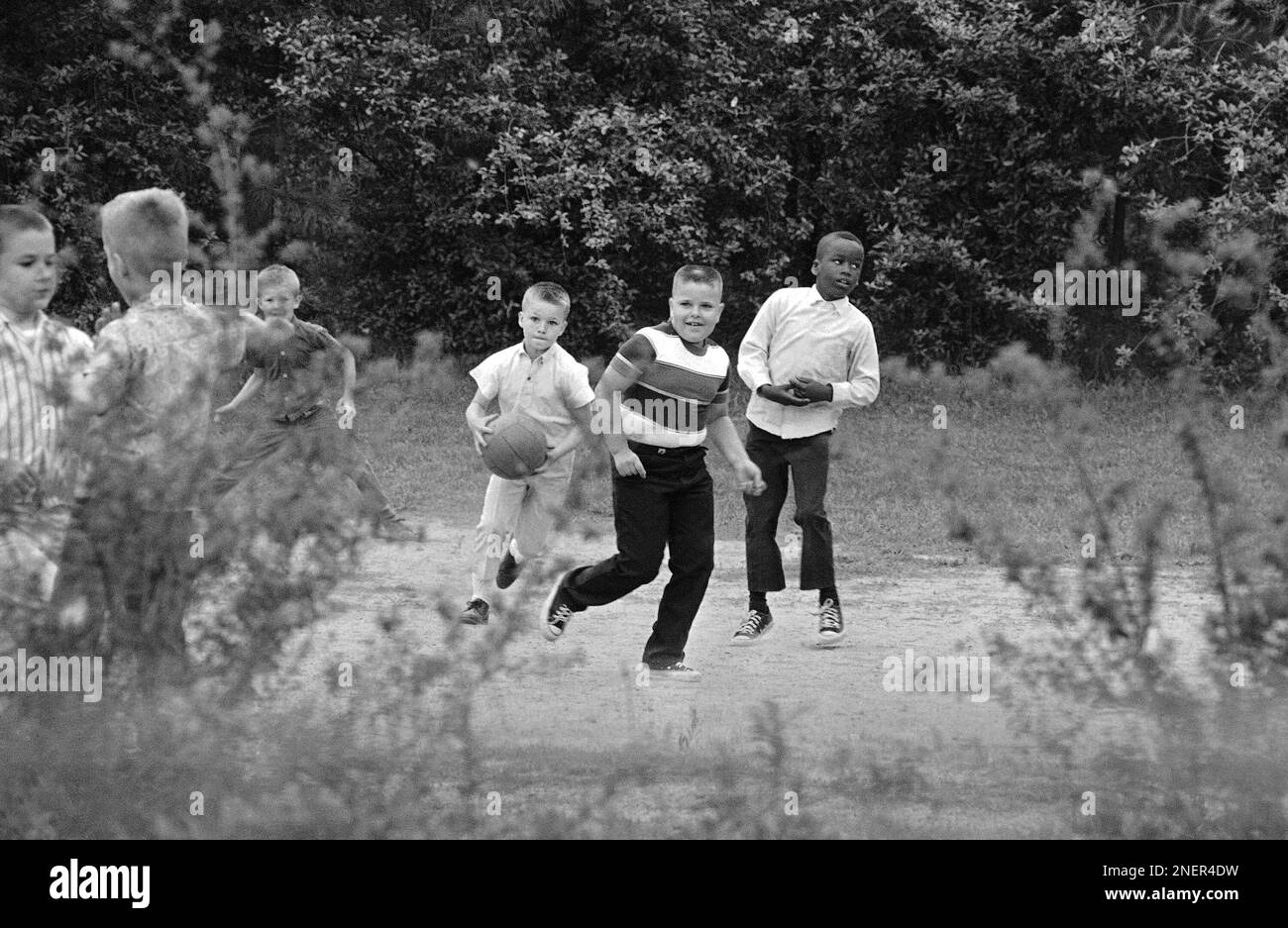 Two white youths romp with a young African American on an Atlanta ...