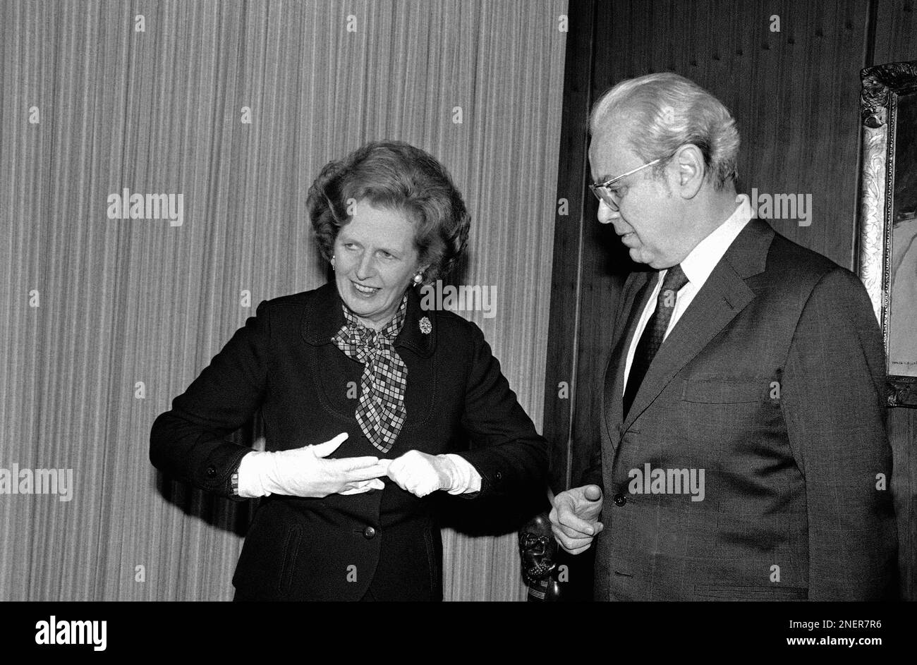 British Prime Minister Margaret Thatcher prepares to remove her gloves ...