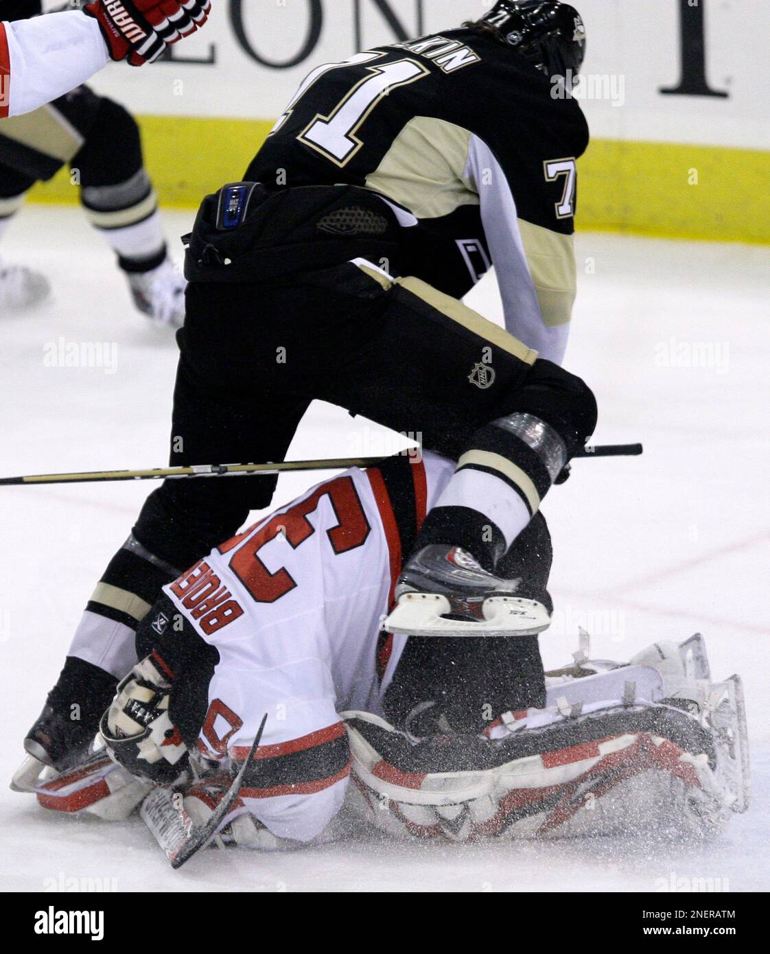 Pittsburgh Penguins Evgeni Malkin top of Russia leap frogs over New Jersey Devils goalie Martin Brodeur in the first period of an NHL hockey game in Pittsburgh Saturday Oct. 24 2009. AP