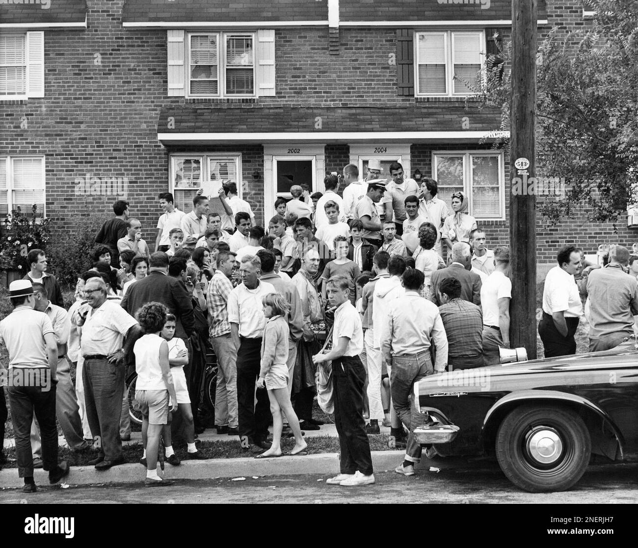 Crowd standing transportation building exterior architecture Black and