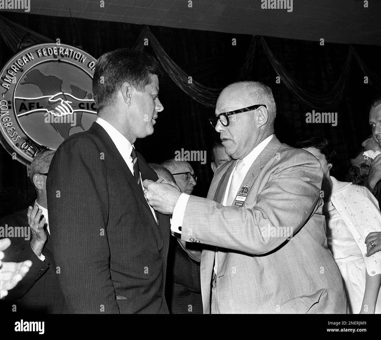 Meany, (right) President of the AFLCIO, pins an AFLCIO