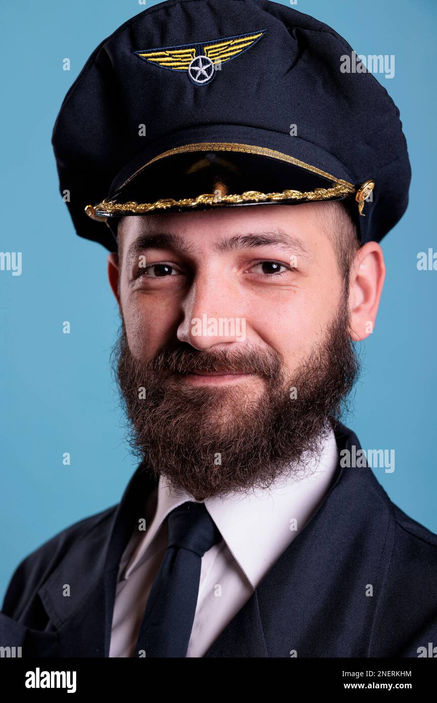 Aircraft captain wearing uniform and hat portrait, confident plane