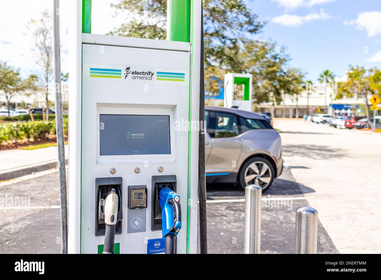 Naples, USA - March 1, 2022: Electrify America EV electric vehicle charger station for charging cars in Florida shopping mall with parked transportati Stock Photo